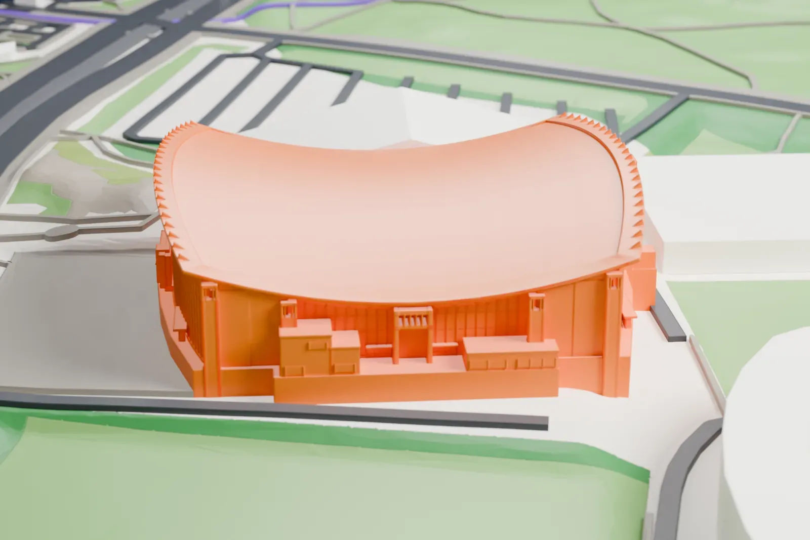 A white 3D print of the Helsinki Ice Hall, an arena with a curving saddle roof rising to tall end arches, among the surrounding streets and buildings.