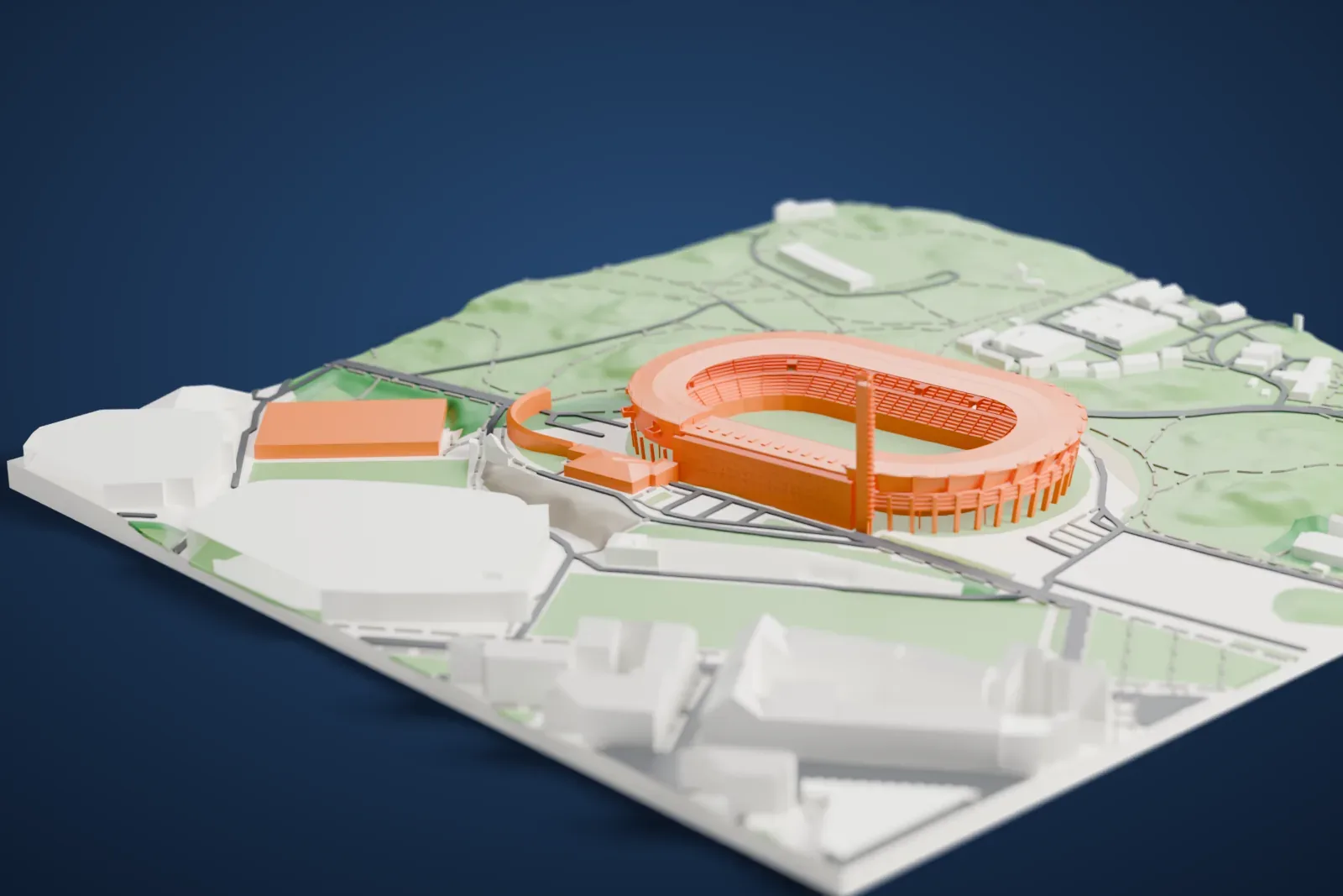 A white 3D print of the Helsinki Olympic Stadium, an oval stadium with a ring roof, a row of slim columns and a tall narrow tower at one end, on a green hillside among roads and low buildings.