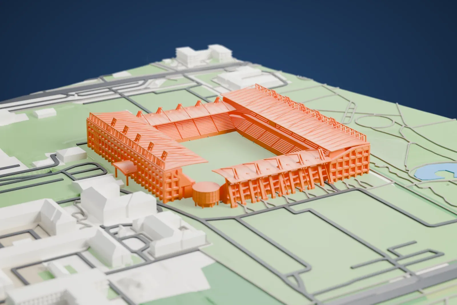 A white 3D print of the Henryk Reyman Municipal Stadium, four curved stands around an open field with tall lighting ladders, among the surrounding streets and buildings of Kraków.