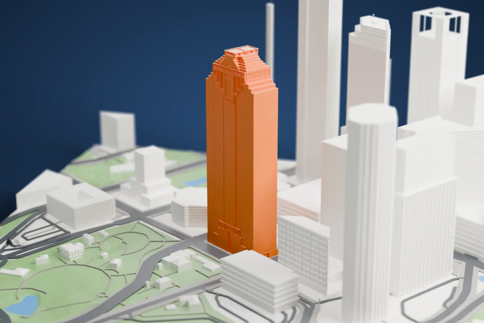 A white 3D print of Heritage Plaza among the surrounding streets and buildings.