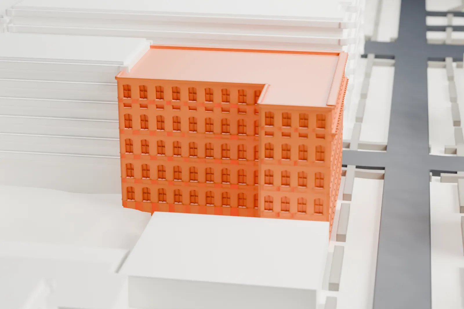 A white 3D print of the Hertlein and Schlatter Silk Trimmings Factory, an L-shaped brick factory with rows of windows, among taller buildings and streets.