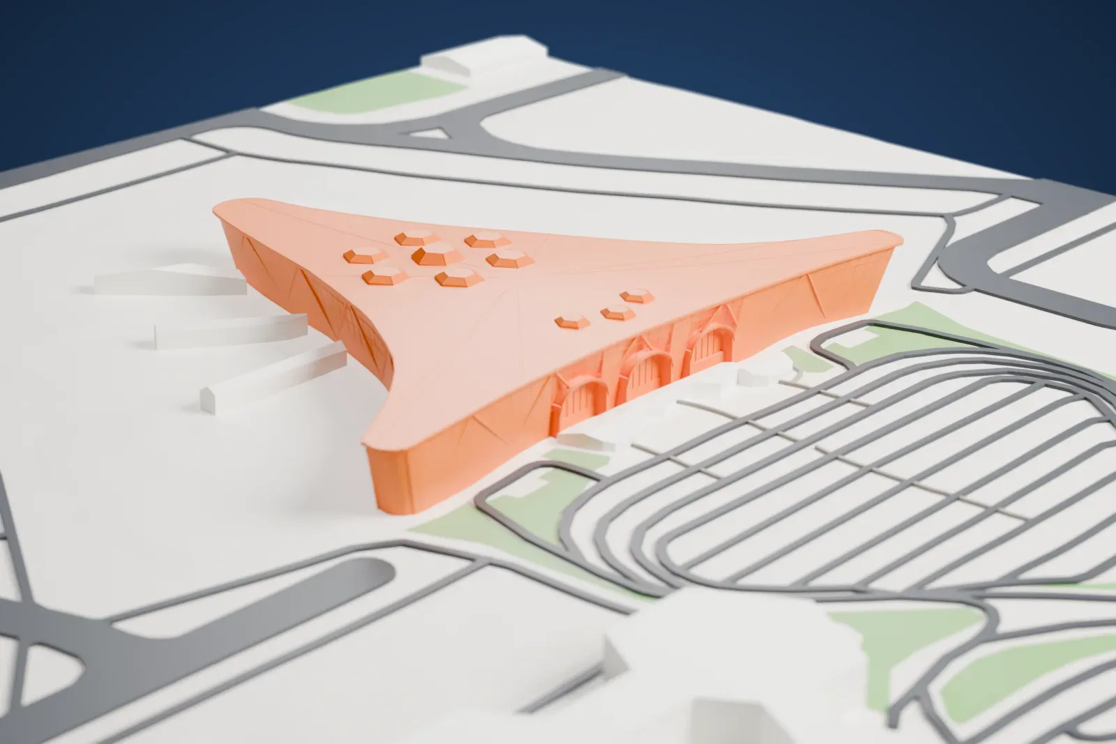 A white 3D print of Terminal 1 at Heydar Aliyev International Airport, a low rounded triangular terminal with a sweeping roof, among airport buildings and roads.