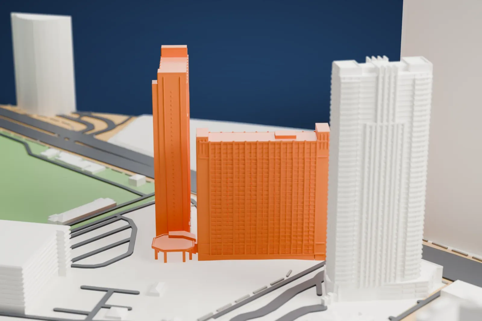 A white 3D print of the two Hilton Grand Vacations Club towers, tall slab-like buildings with gridded walls and a small canopy at the base, among roads and taller neighboring buildings.