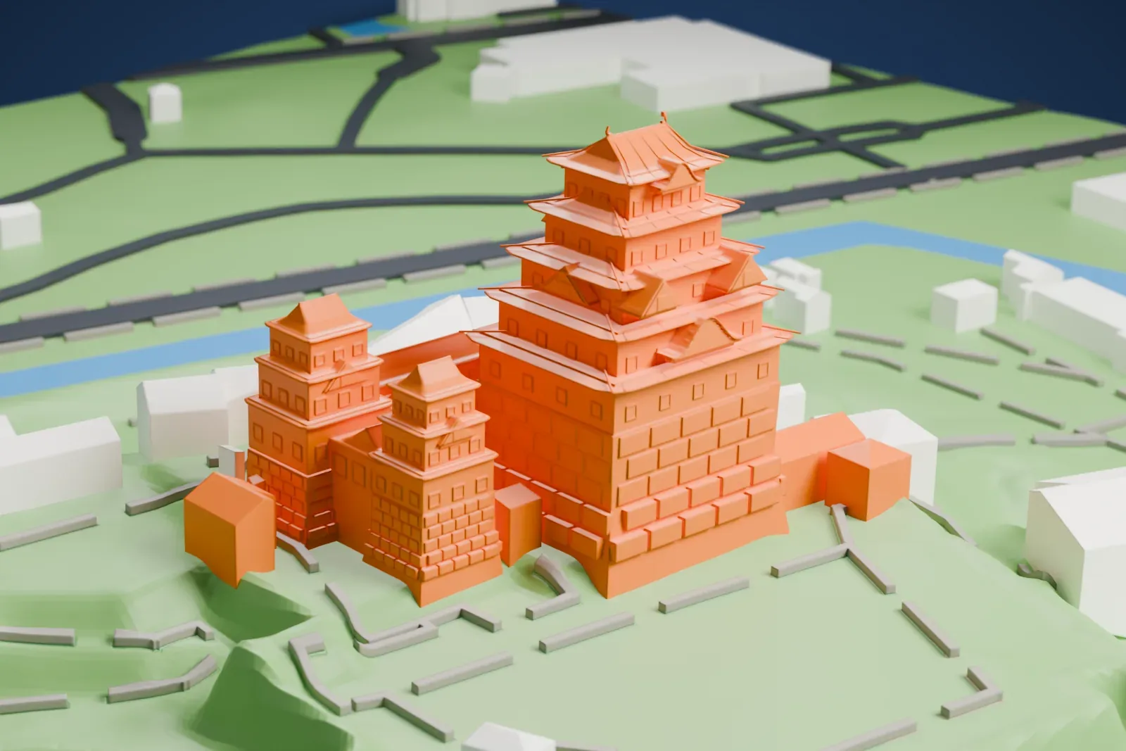 A white 3D print of Himeji Castle, a cluster of stacked keeps with layered gabled roofs on a green hillside, with water and small buildings nearby.