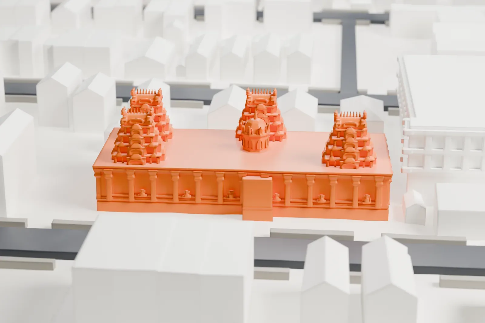 A white 3D print of the Hindu Temple Society of North America temple, a long low building topped with several ornate tiered towers, surrounded by streets and smaller buildings.