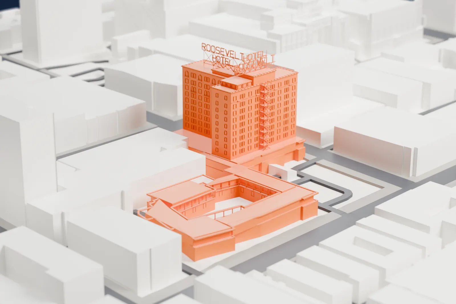 A white 3D print of the Hollywood Roosevelt Hotel, a tall block with rows of windows, standing on a street of surrounding buildings.