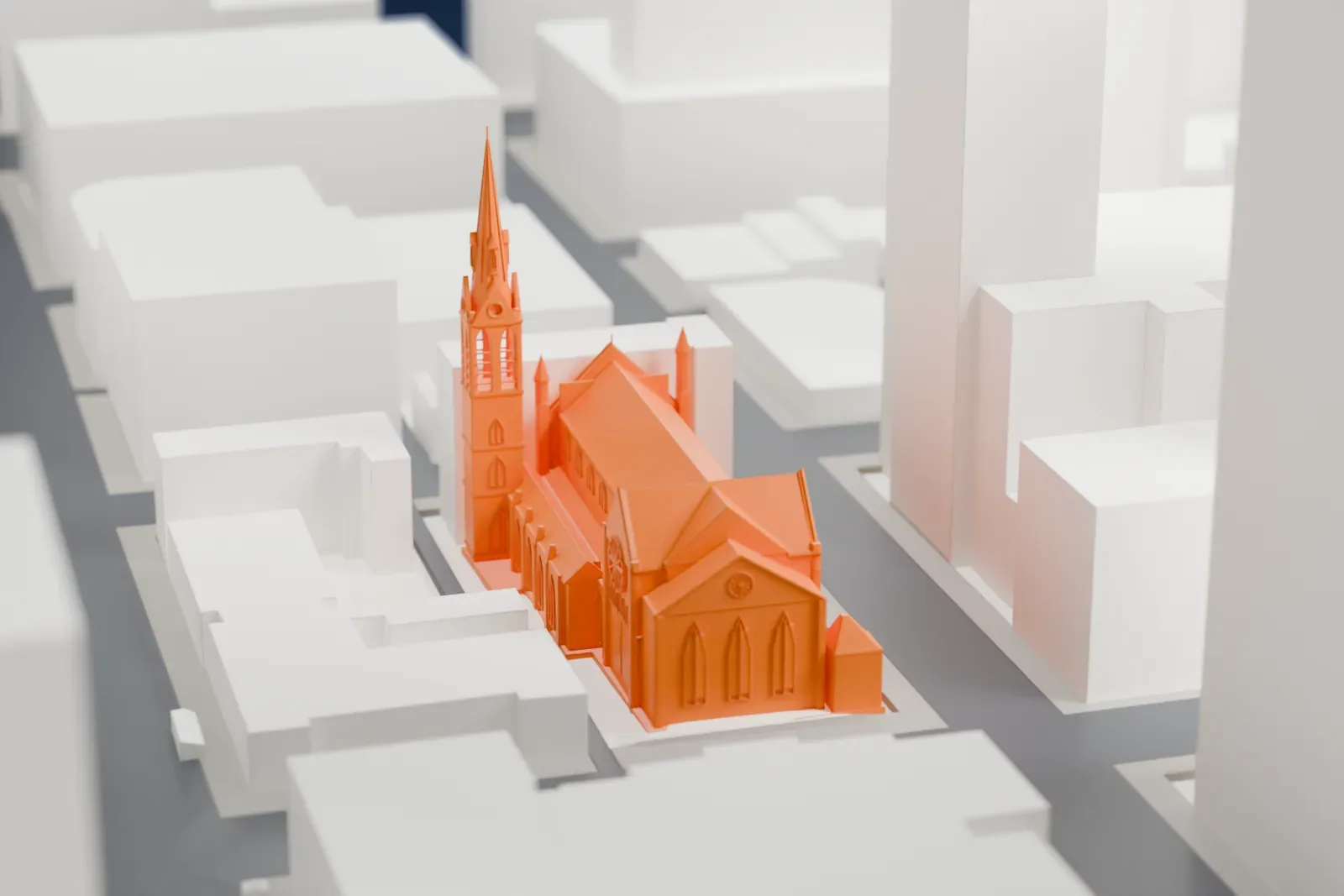 A white 3D print of Holy Name Cathedral, a long, low church among the surrounding streets and buildings of Chicago.