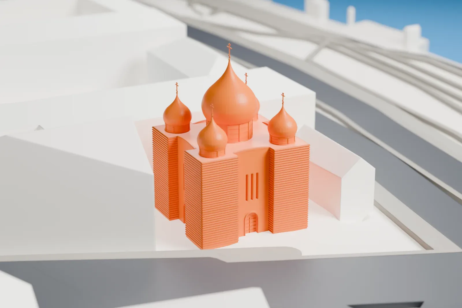 A white 3D print of the Holy Trinity Cathedral with its five domes, among the buildings near the Seine.