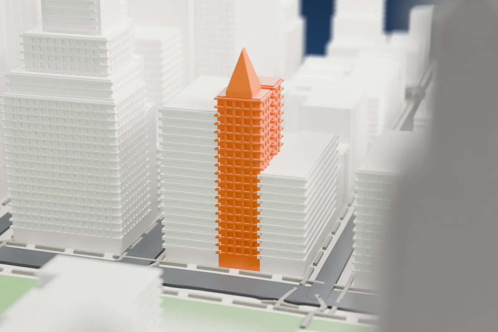 A white 3D print of the Home Life Building, a narrow ornate tower with a steep gabled top, squeezed between taller neighboring buildings near a park.