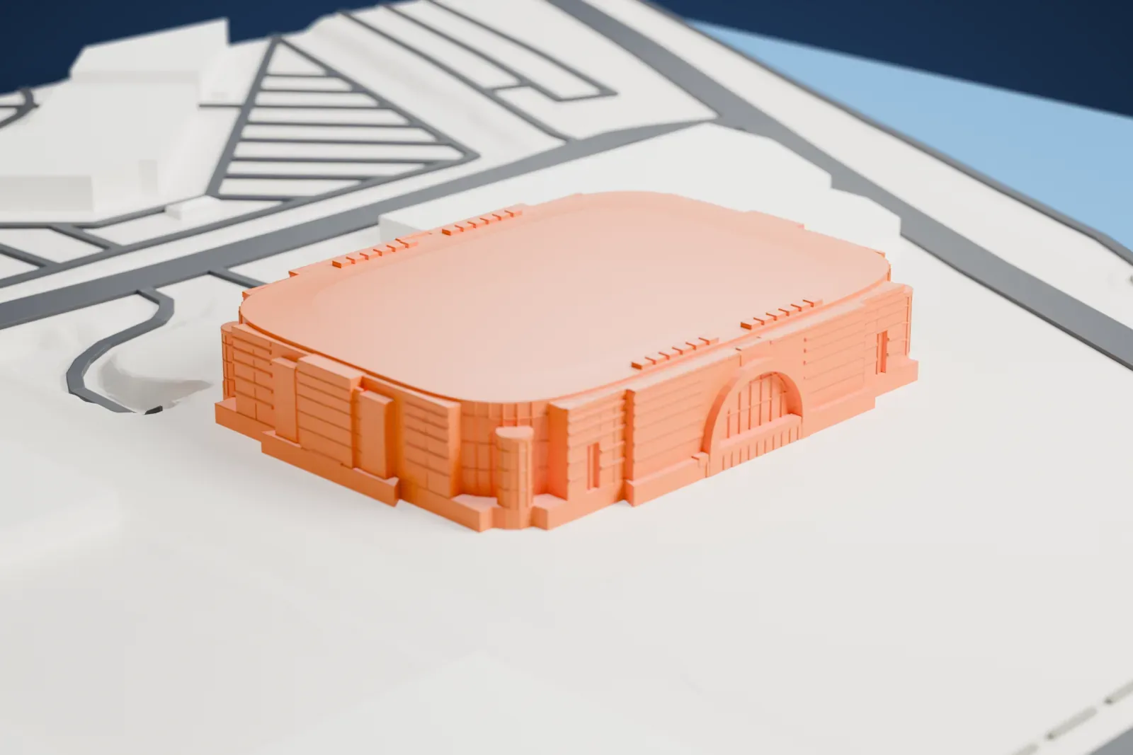 A white 3D print of Honda Center, its arched entrance facades and glass corner drums below a low roof, among the surrounding streets and buildings.