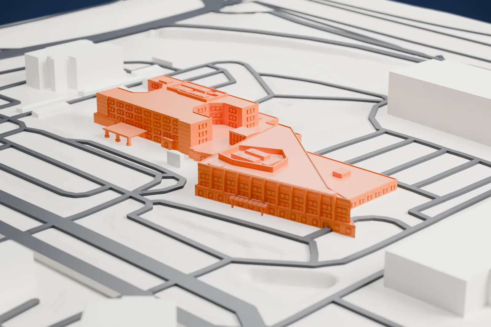 A white 3D print of HonorHealth Deer Valley Medical Center, a hospital campus with several connected buildings among surrounding streets and buildings.
