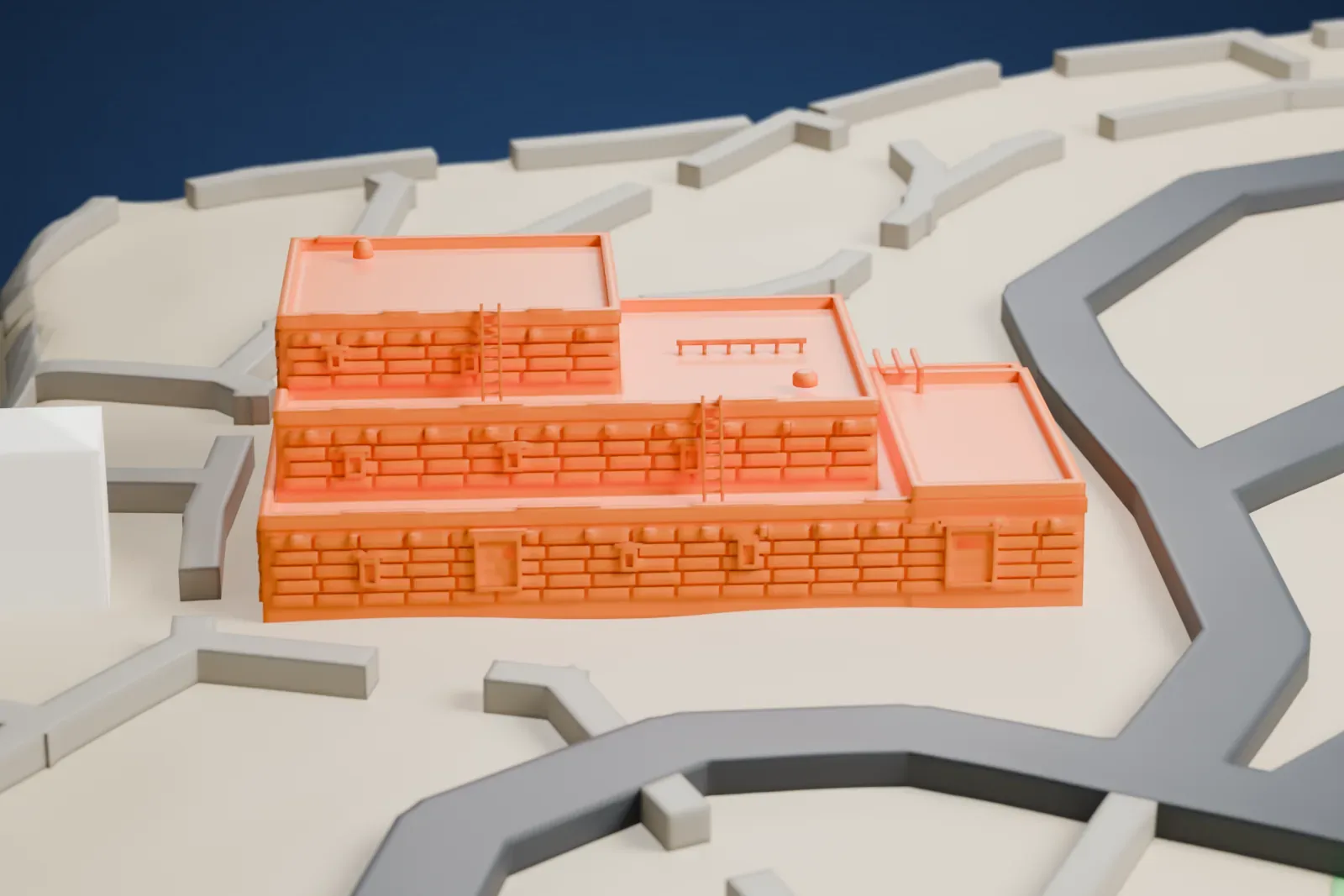 A white 3D print of the Hopi House with stepped terraces, ladders, and textured walls, surrounded by paths, low walls, open terrain, and nearby buildings.