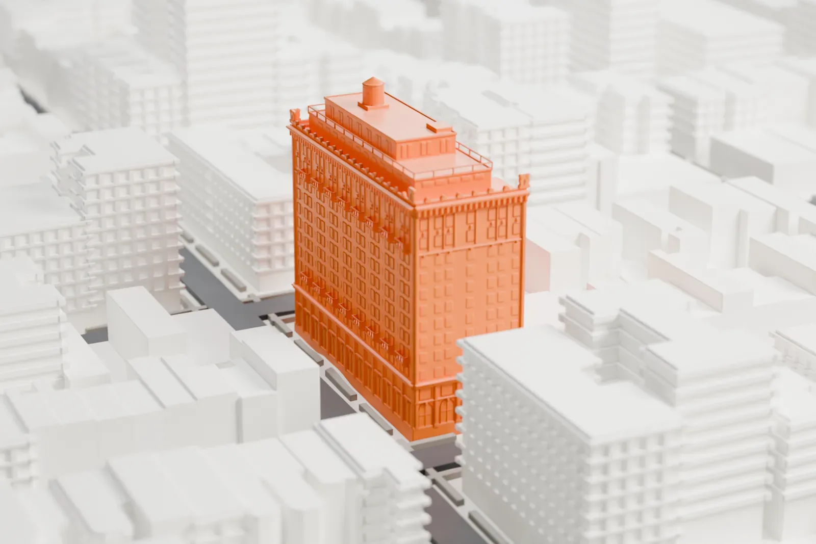 A white 3D print of the Hotel Bossert, a tall stepped block with a rooftop tank, standing among lower buildings and streets.