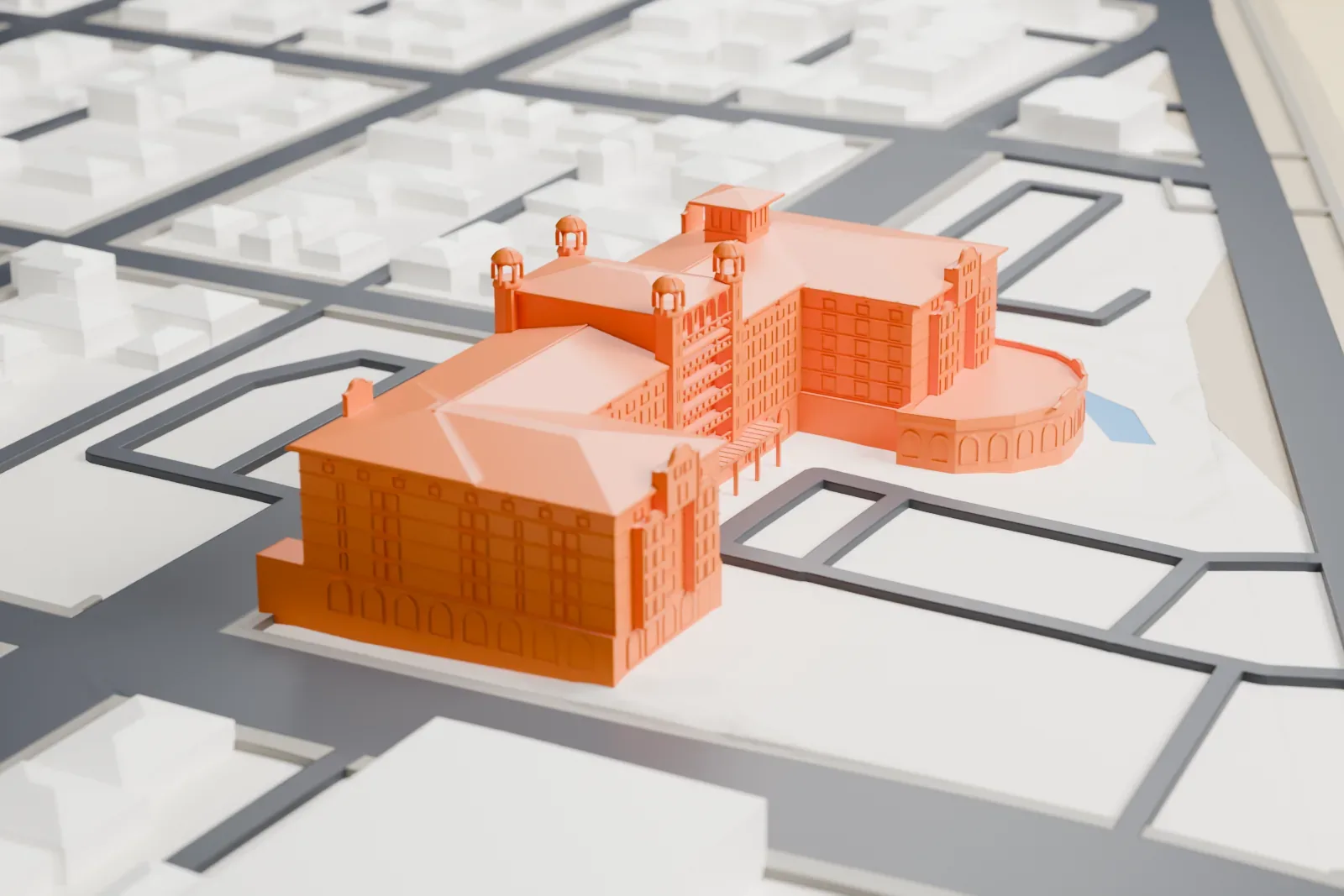 A white 3D print of the Hotel Galvez, with its raised central pavilion, four corner turrets and low tiled roofs, among surrounding streets and buildings.