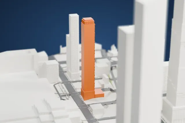 A white 3D print of the Hotel Meta model in New York, with the streets around it.
