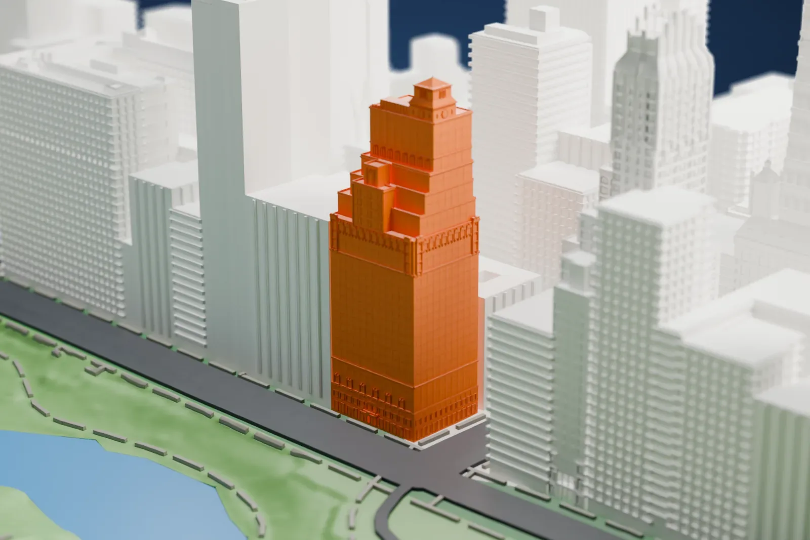 A white 3D print of the Hotel St. Moritz, a stepped tower with a small rooftop pavilion, beside a park with a pond and taller buildings around it.