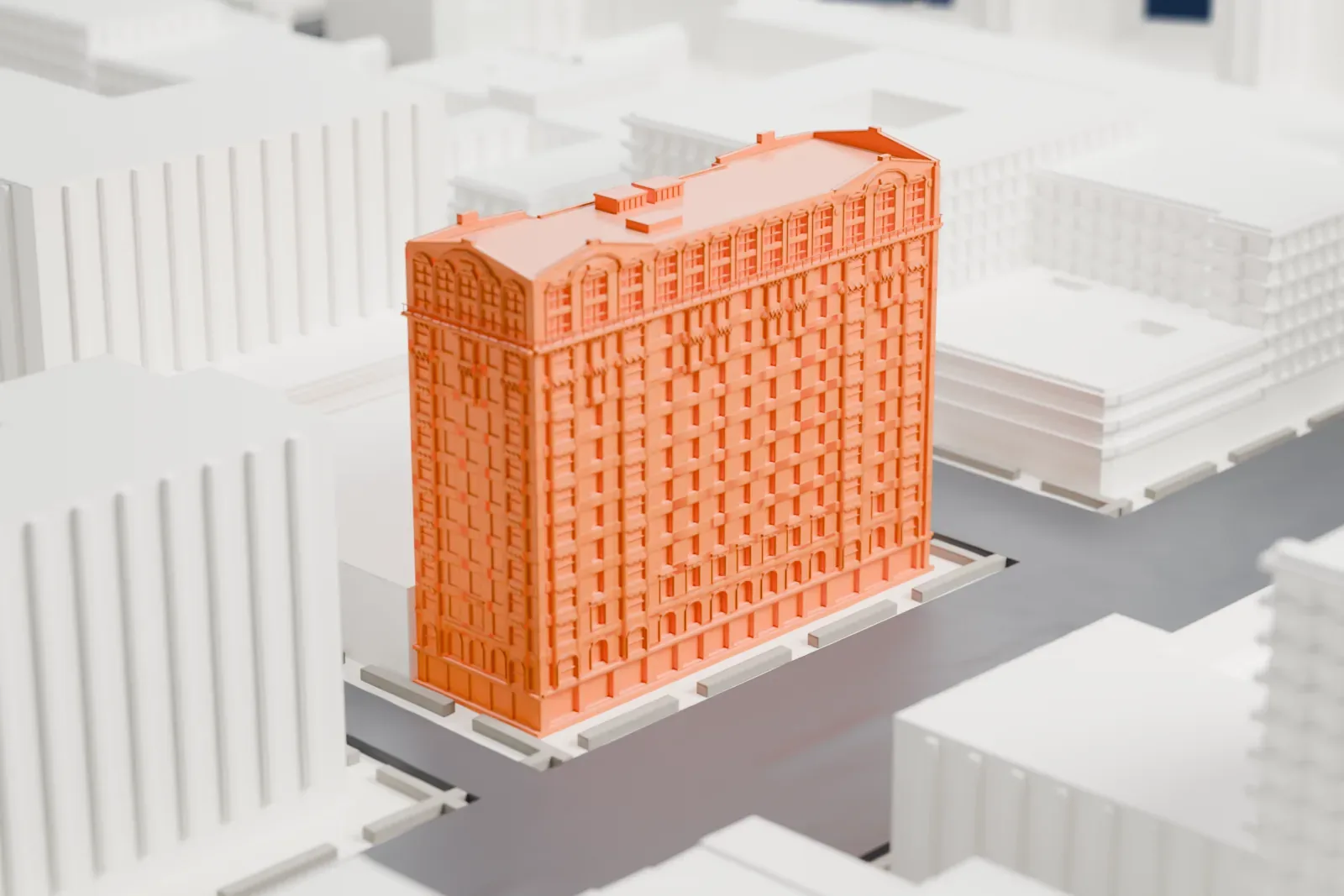 A white 3D print of the Hotel Theresa, a tall block with an ornate facade and arched top windows, standing at a street corner.