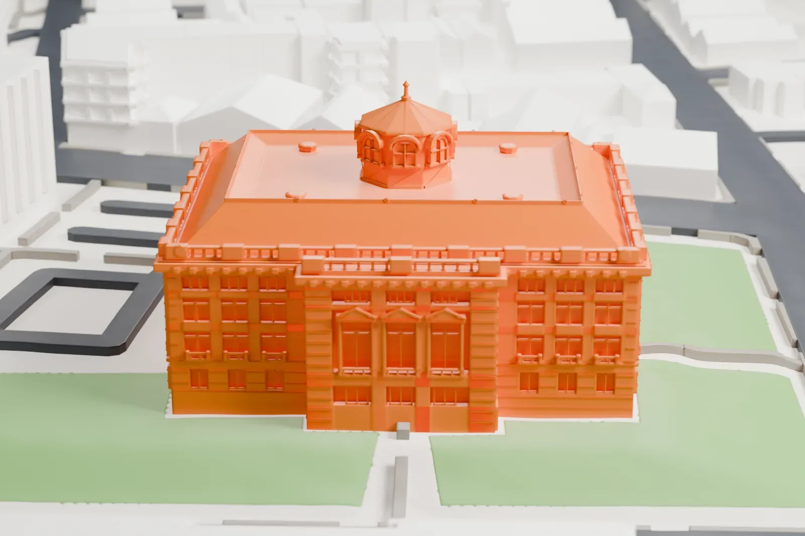 A white 3D print of the Hudson County Courthouse, a large columned building with a small domed cupola on its roof, set on green lawns among streets.