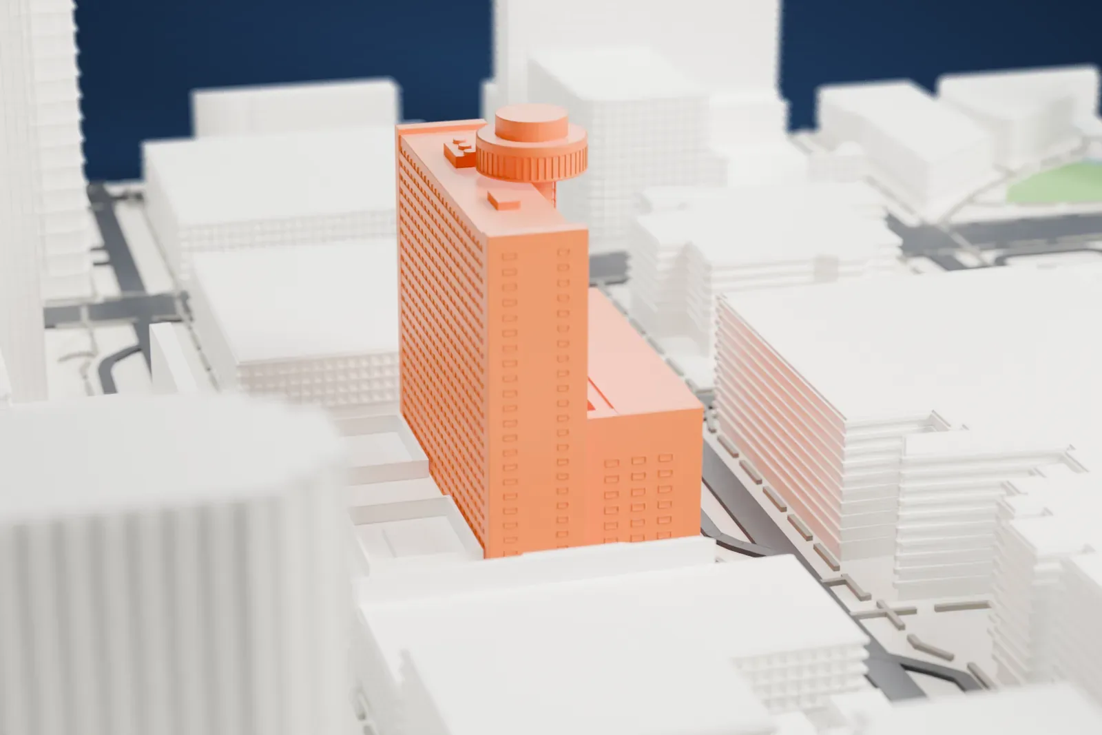A white 3D print of the Hyatt Regency Phoenix, a large block building with a round restaurant disc on a slim shaft above its roof, among city streets and nearby buildings.