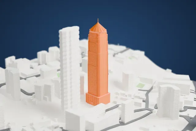 A white 3D print of the The Imperial Tower 1 model in Mumbai, with the streets around it.