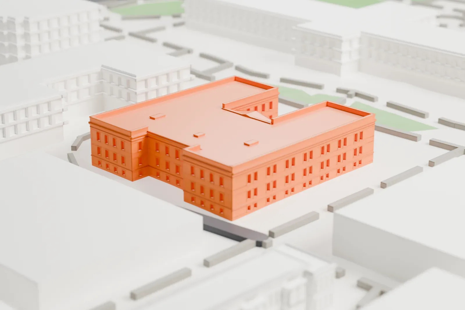 A white 3D print of the Industrial Arts Building, a two-story H-shaped building with a columned entrance, among campus paths, grass and larger buildings.