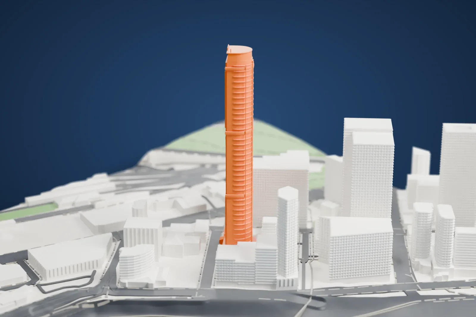 A white 3D print of Infinity Tower, a very tall, slender tower with a rounded profile and horizontal bands, rising among lower buildings near a wide stretch of water.
