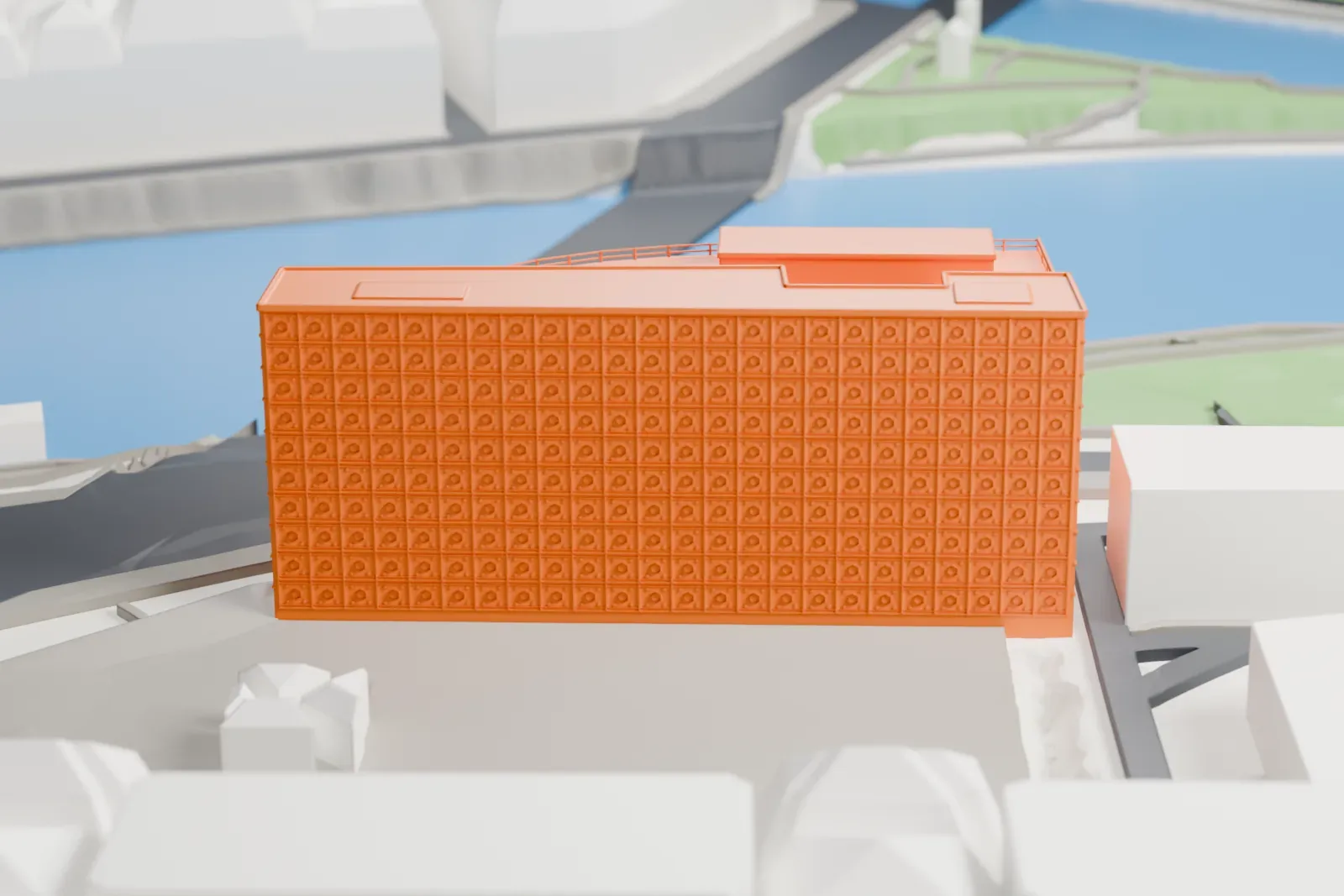 A white 3D print of the Institut du monde arabe, a block with a glass front, beside the Seine in Paris.