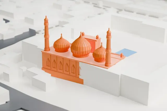 A white 3D print of the Jama Masjid, a prayer hall with three onion domes, two slender minarets and a tall arched gateway, surrounded by an open courtyard, a road and dense buildings.