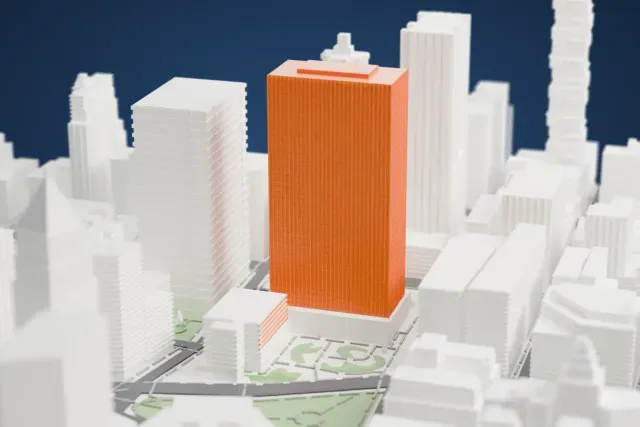 A white 3D print of the Javits Federal Building model in New York, with the streets around it.