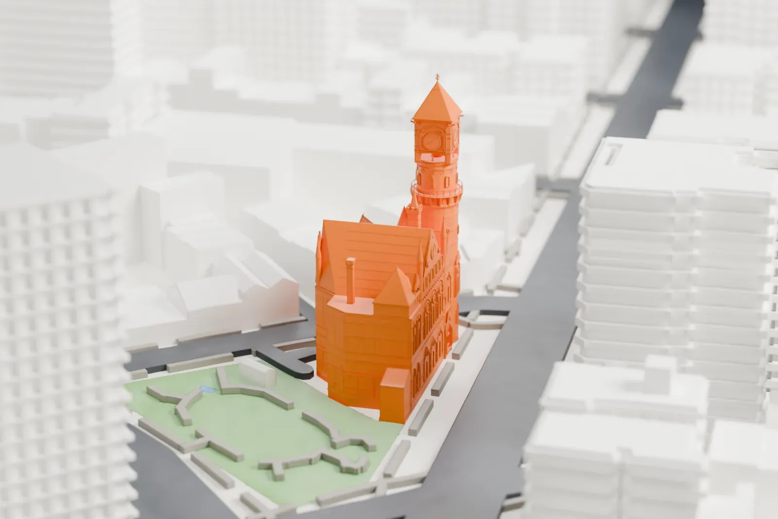 A white 3D print of the Jefferson Market Library, a Gothic building with a tall clock tower and steep gabled roofs, beside a small green park and city streets.