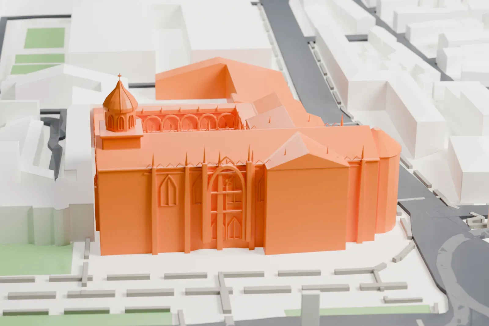 A white 3D print of the Jerónimos Monastery, a long church with slim pinnacles and a domed tower beside a two-level arched cloister, set among streets, lawns and low buildings.
