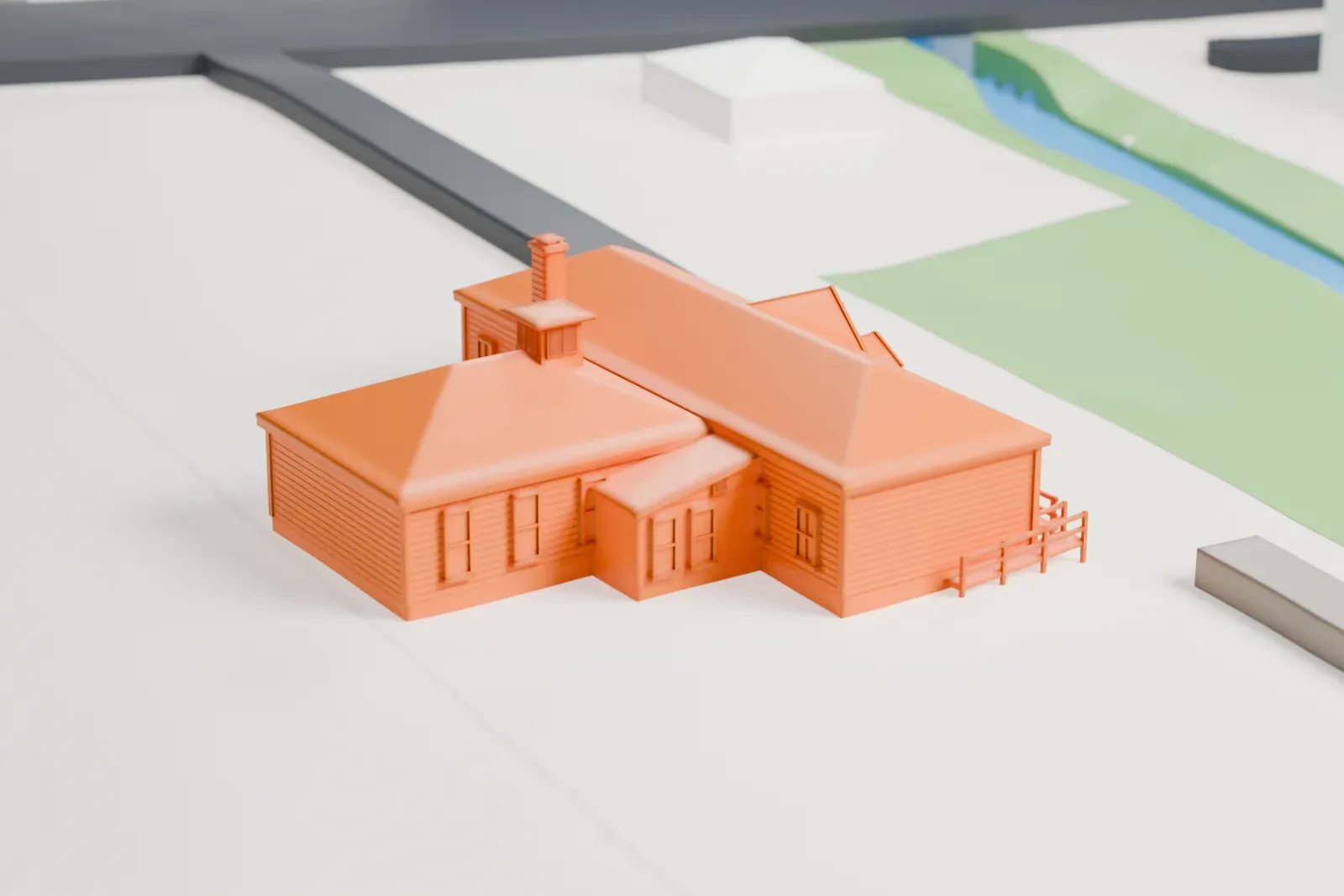 A white 3D print of the Jerusalem District No. 5 Schoolhouse, a T-shaped hipped-roof building with a small entrance portico, on open ground beside a road.