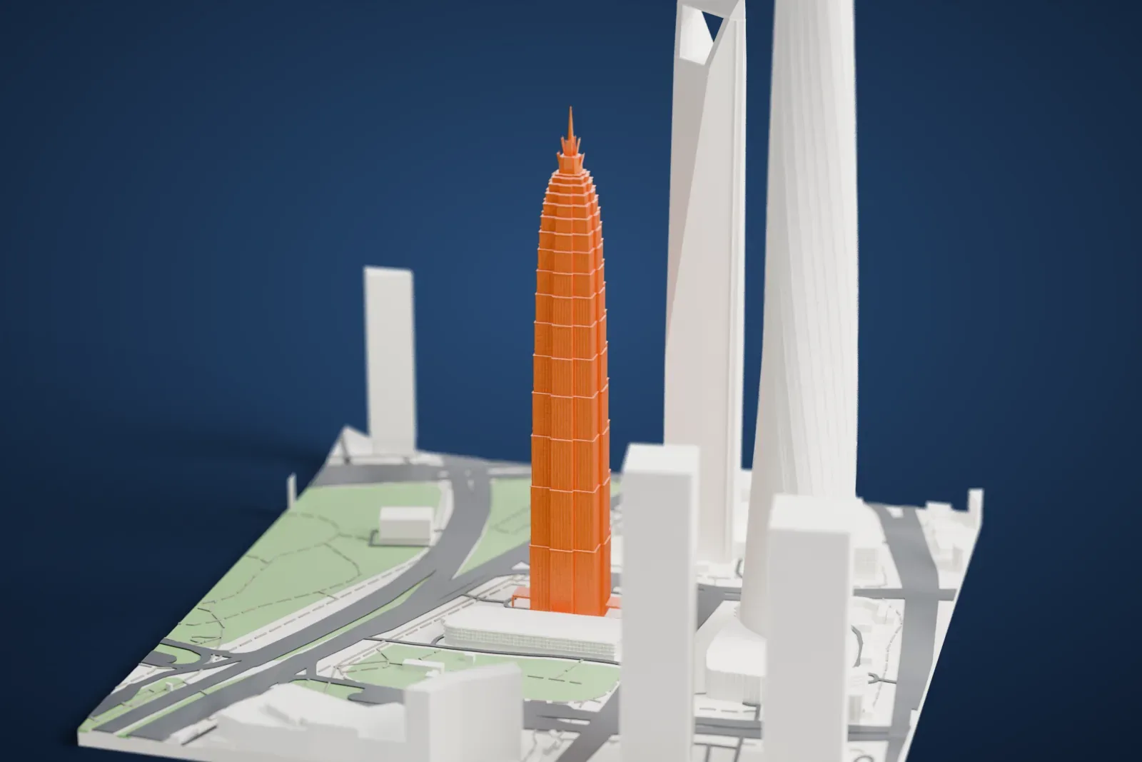 A white 3D print of the Jin Mao Tower, a slim, tiered tower with a spire, standing beside two other tall towers with roads and green space at its base.