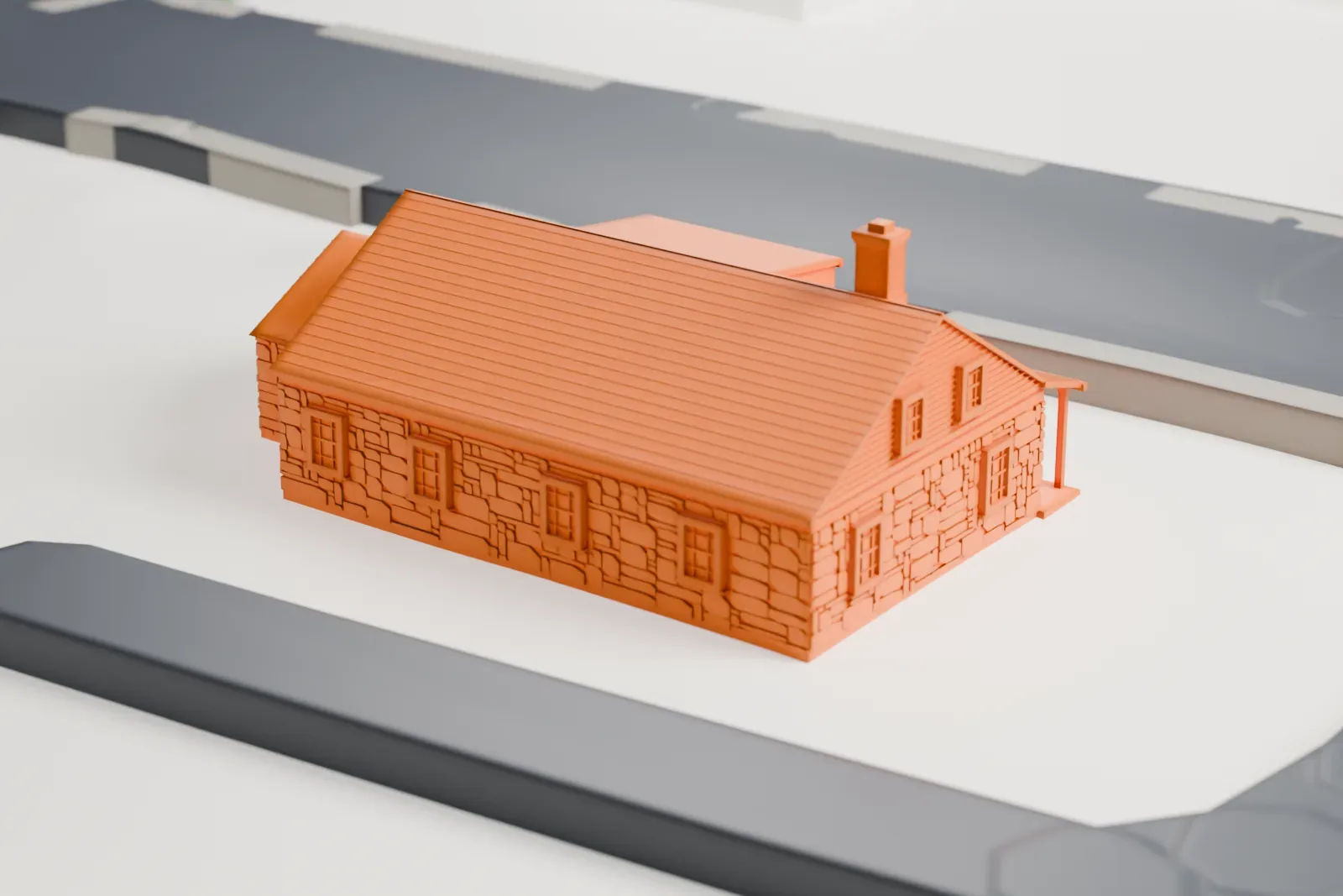 A white 3D print of a stone tavern with a steep shingled roof, a dormer and a long porch, beside a curving road.