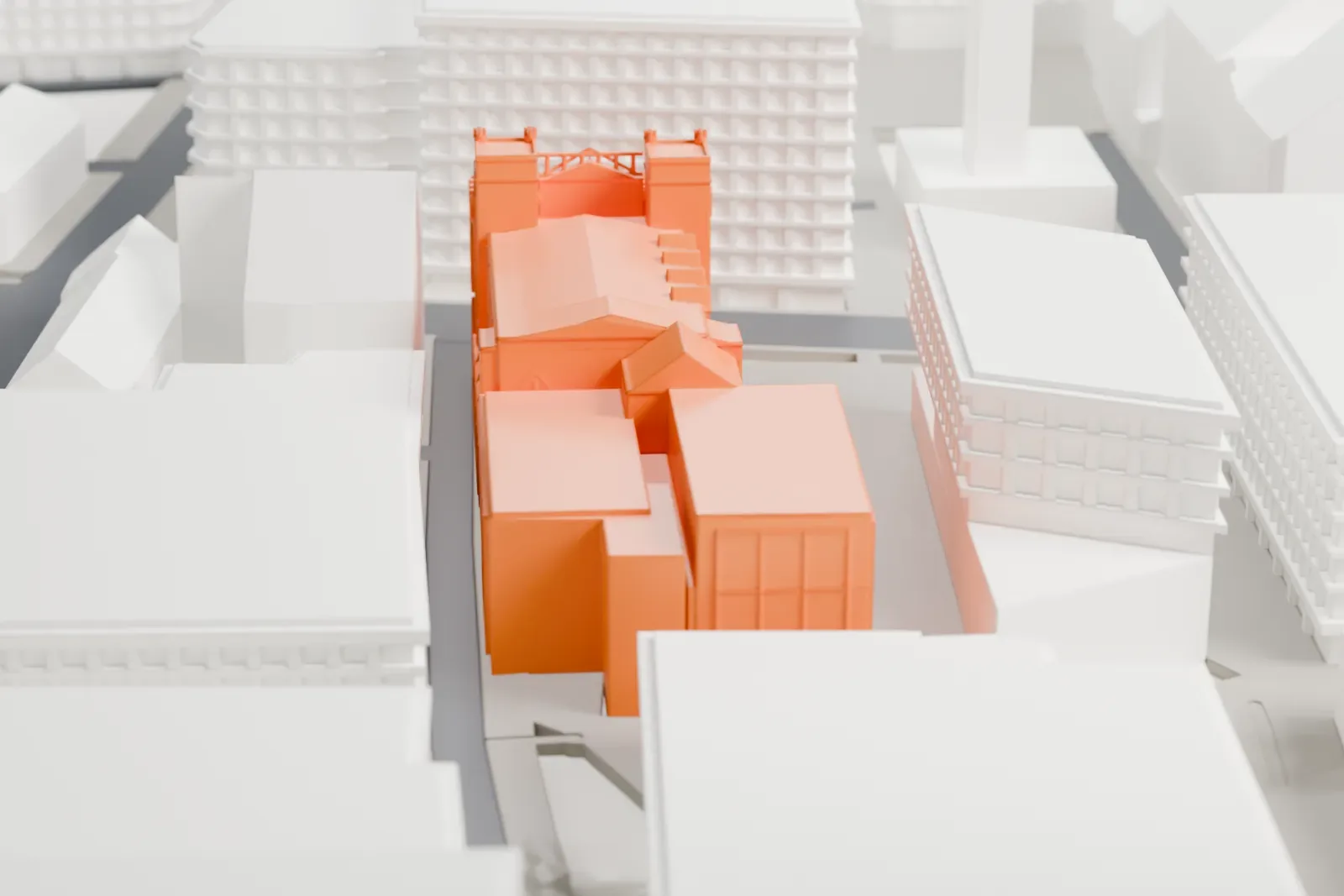 A white 3D print of the John Rylands Research Institute and Library in Manchester, with the surrounding streets and buildings around it.