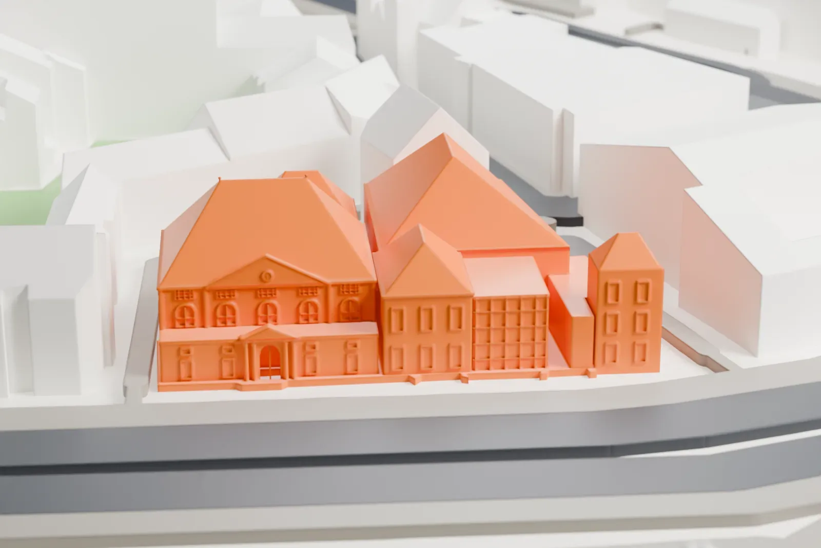A white 3D print of the Joods Historisch Museum, a group of former synagogues, among the surrounding Amsterdam streets and buildings.