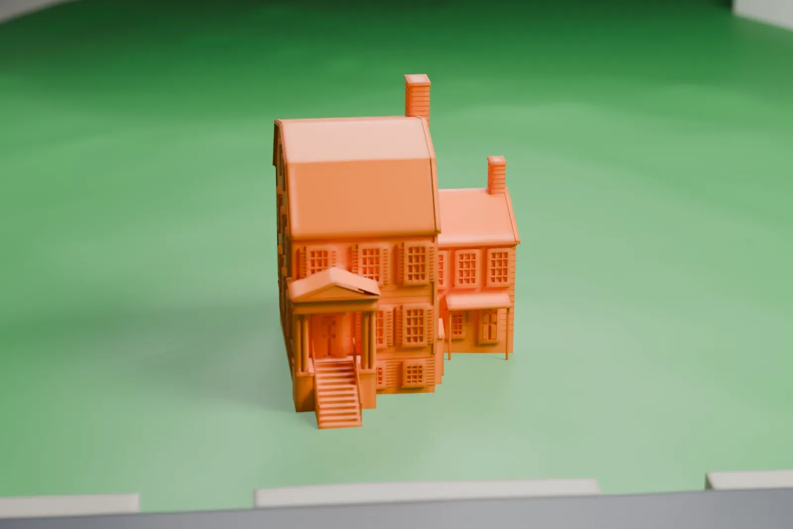 A white 3D print of the Joseph Jackson House, a tall frame house with a two-slope roof, tall chimneys and a columned entrance porch, standing on a lawn beside a road.