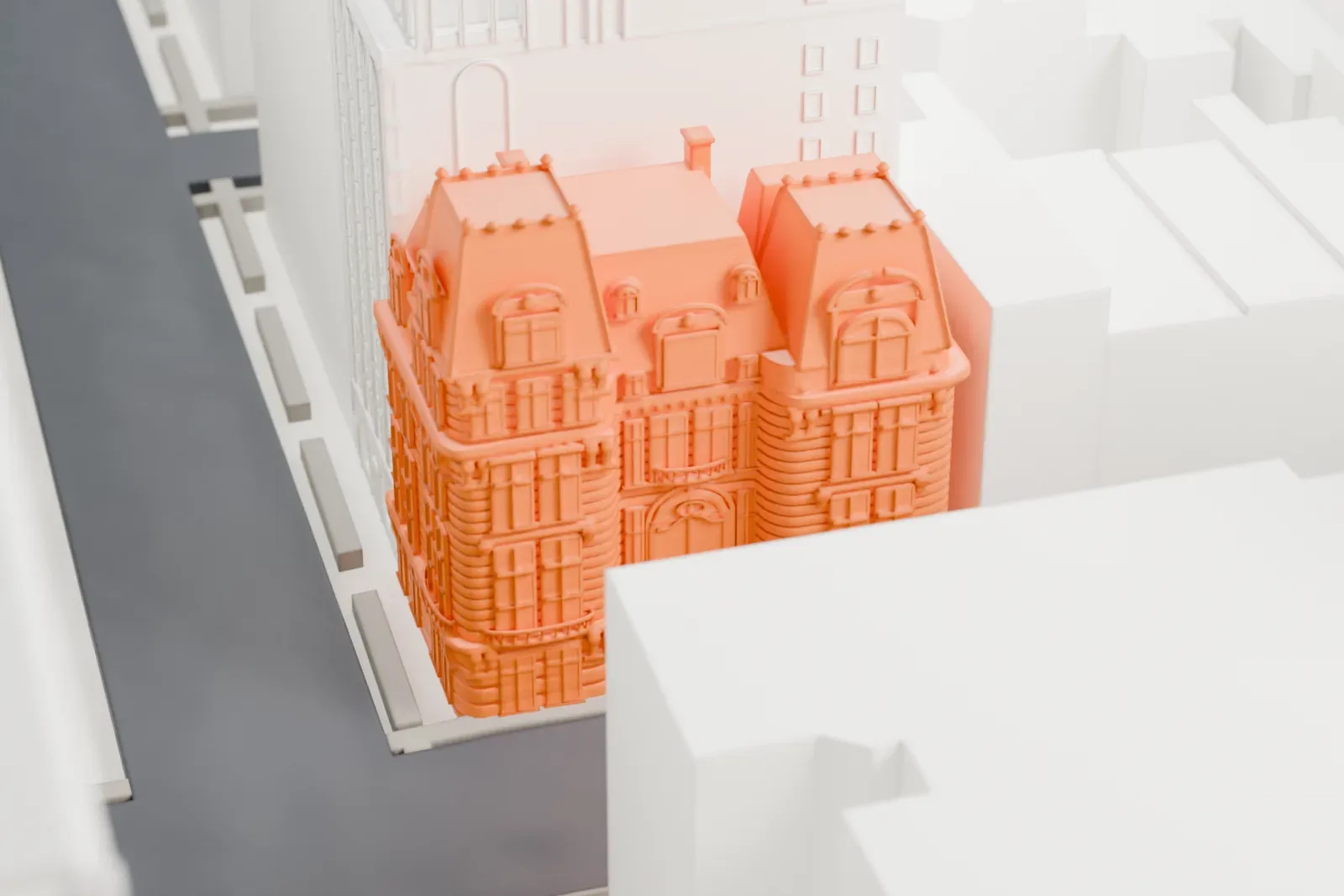 A white 3D print of the Joseph Raphael De Lamar House, a small five-story mansion with a mansard roof and three projecting bays, squeezed between much taller buildings.