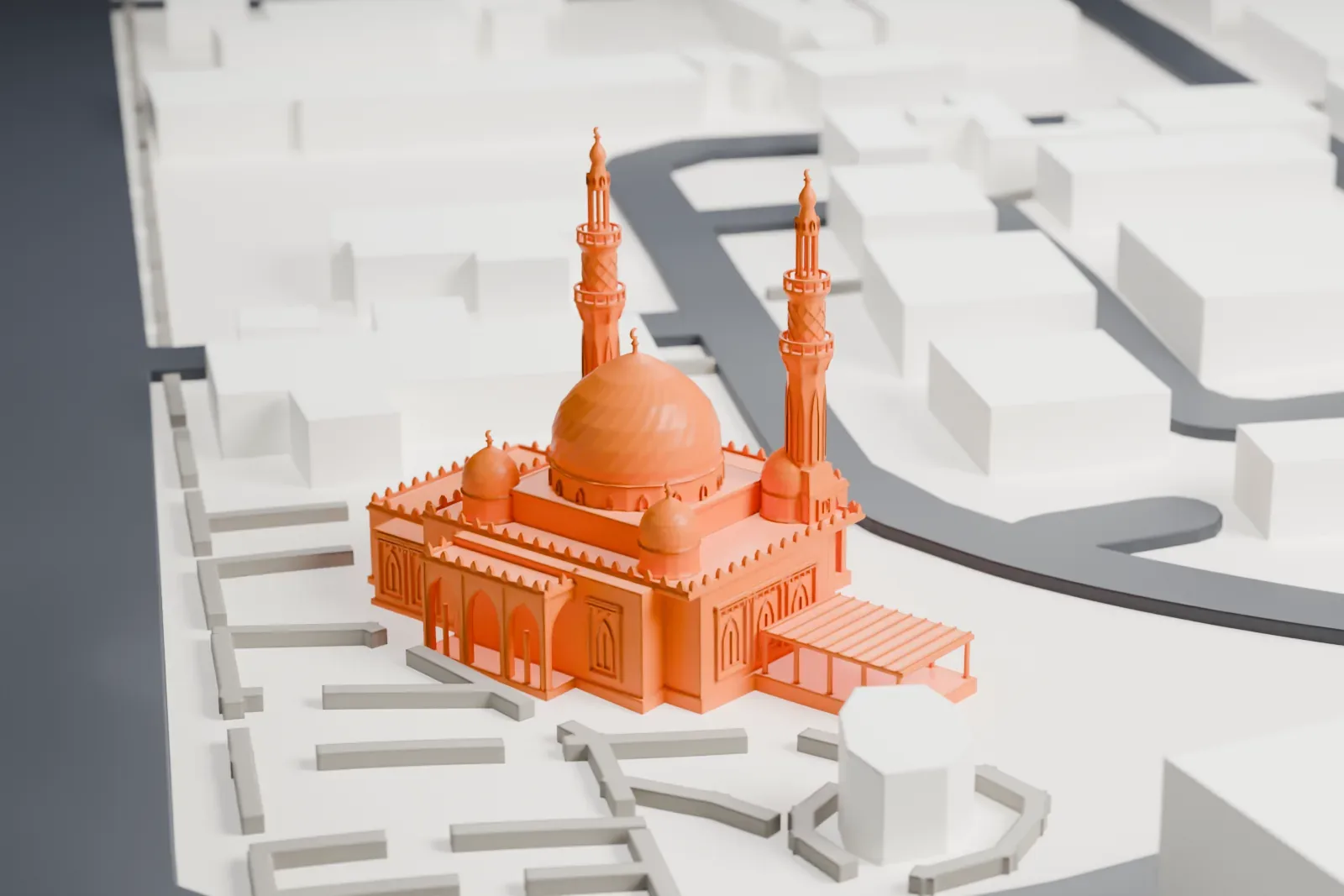 A white 3D print of Jumeirah Mosque, with a large ribbed dome, smaller domes and two slender minarets, among low buildings and wide roads.