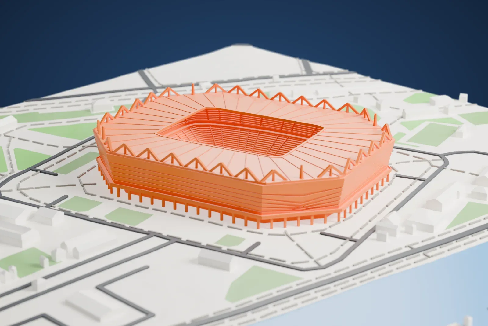 A white 3D print of Kaliningrad Stadium, a banded octagonal box ringed by white A-frame pylons above the roof, among streets and buildings.