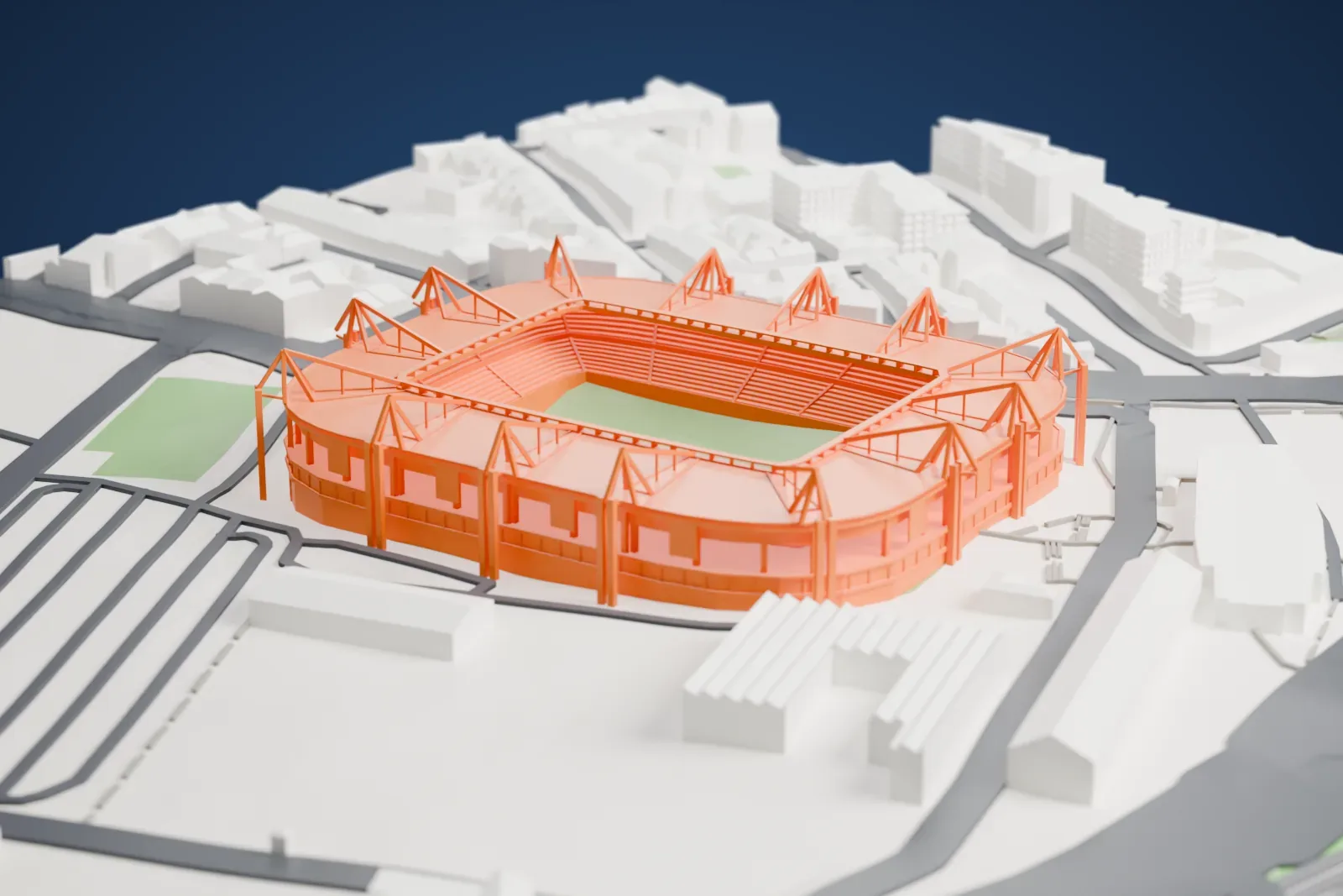 A white 3D print of Karaiskakis Stadium, a closed bowl under a continuous ring roof crowned by fourteen pyramid pylons, among streets and buildings.