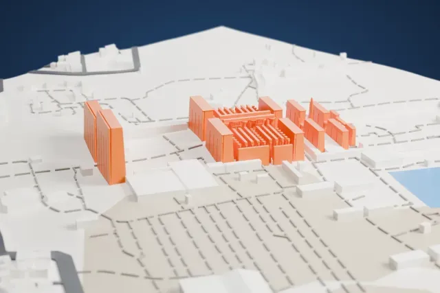 A white 3D print of the Karnak Temple complex, a group of huge sloping gateway towers and a hall of slim columns, standing among low buildings and streets.