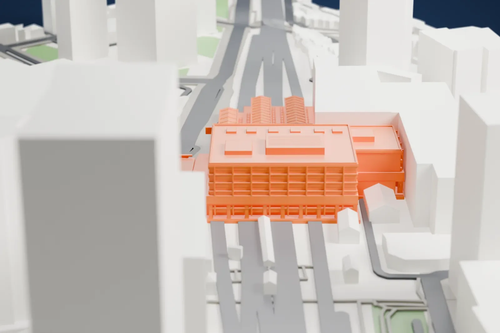 A white 3D print of Kawasaki Station, an elevated station building, among the surrounding city buildings.