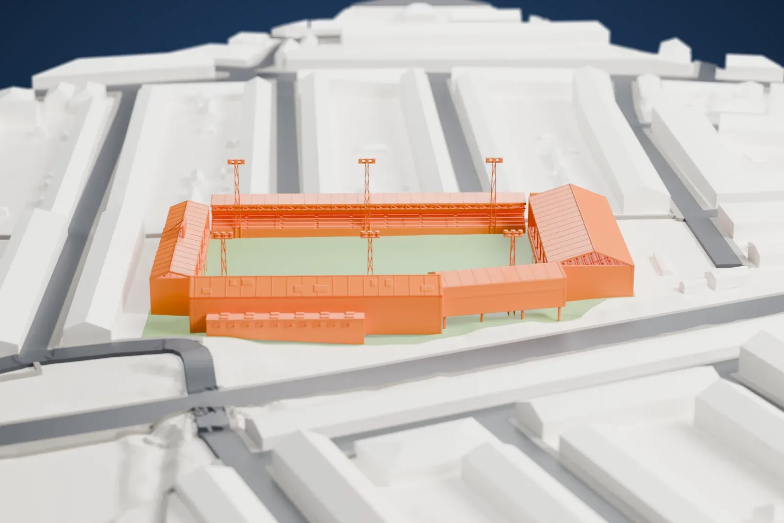 A white 3D print of Kenilworth Road, with separate stands of different heights around an open pitch and six slender floodlight pylons, among surrounding streets and buildings.