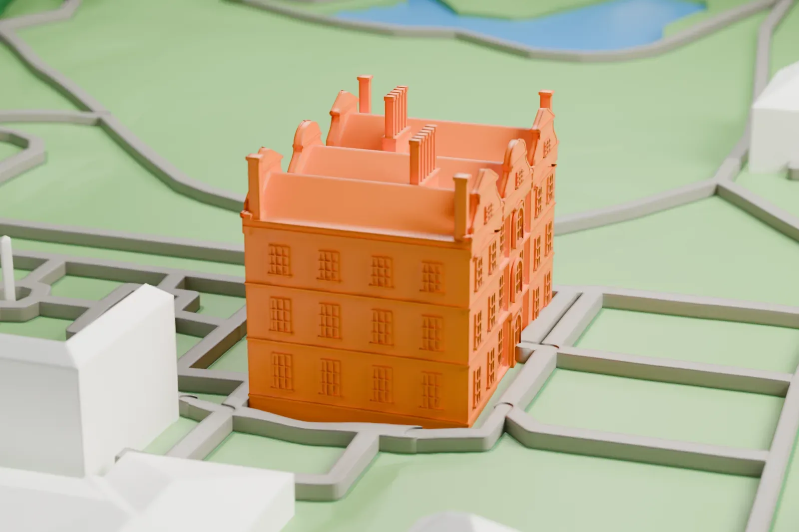 A white 3D print of Kew Palace, a low house with a small wing, standing on green grounds with other buildings nearby.