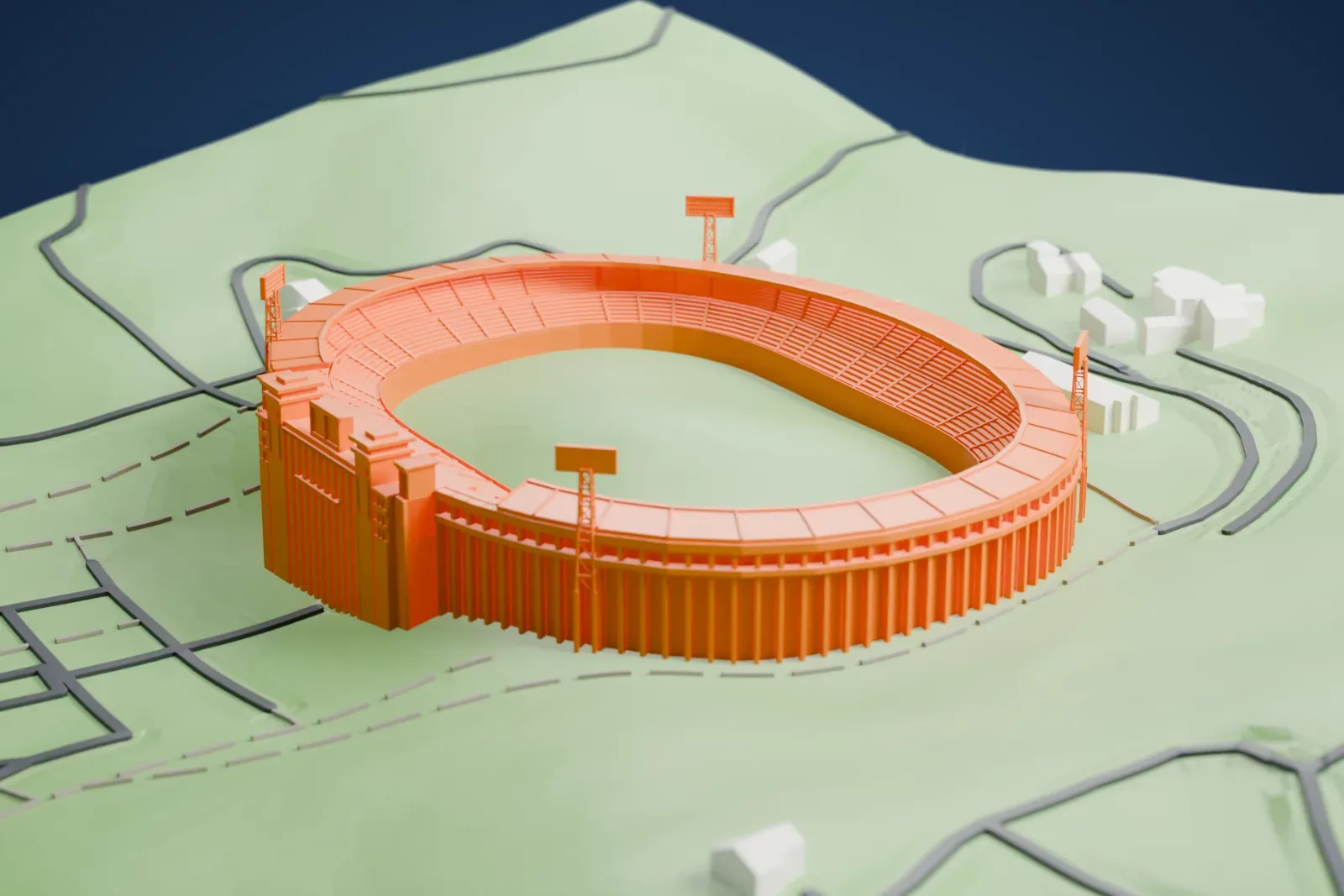 A white 3D print of Kim Il Sung Stadium, an oval bowl with a colonnaded main building on one side and four lattice floodlight towers, among streets and buildings.