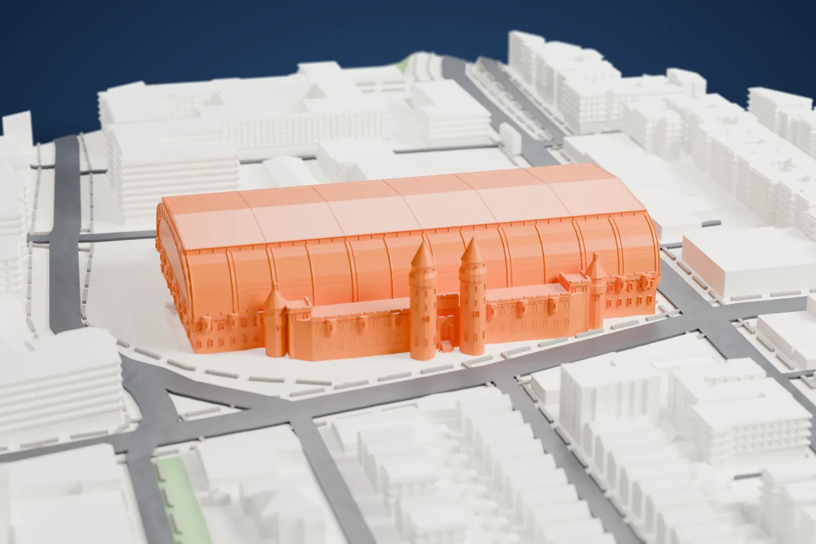 A white 3D print of the Kingsbridge Armory, a huge vaulted hall with small turrets at its ends, surrounded by streets and low buildings.
