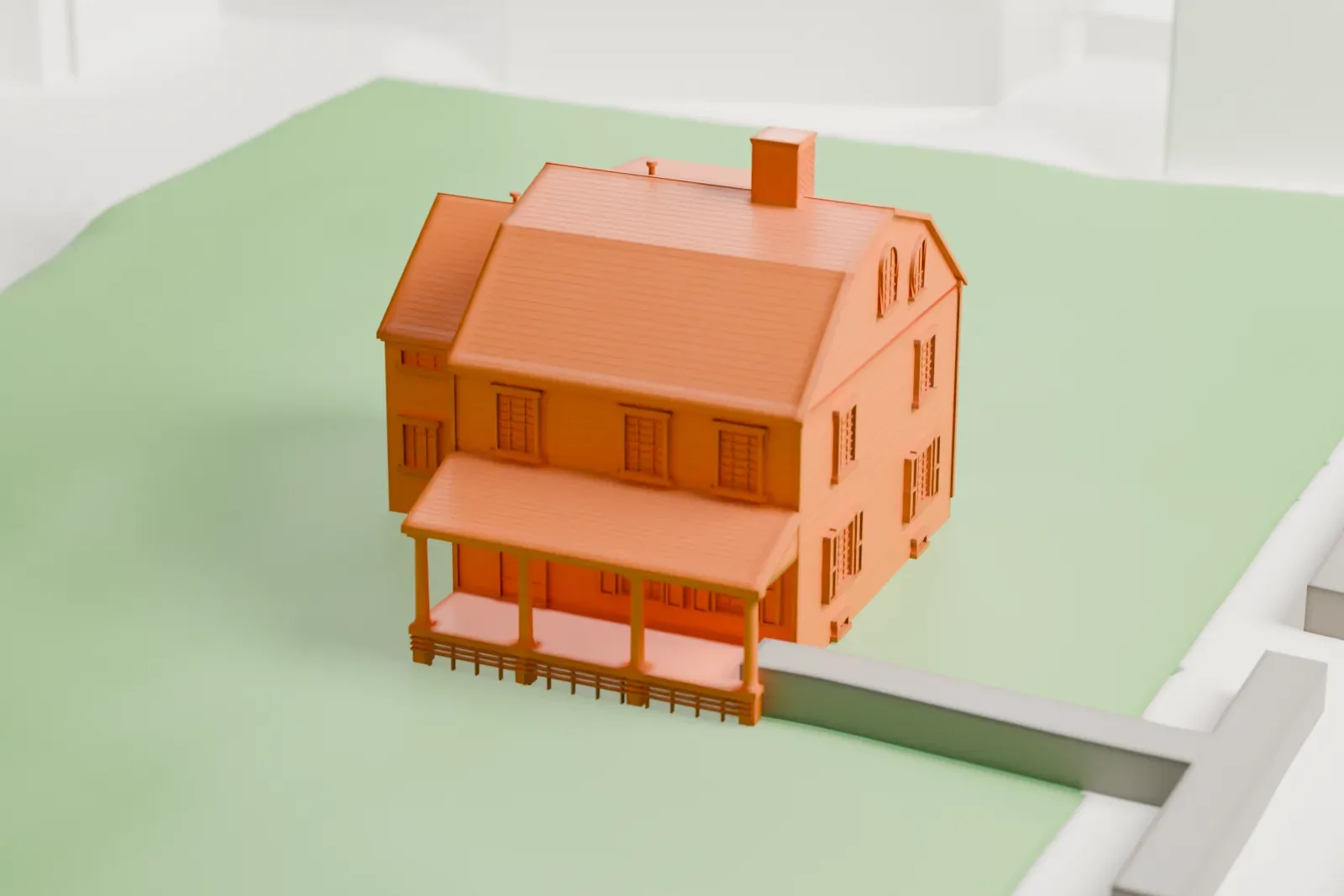 A white 3D print of Kingsland Homestead, a two-story house with a porch and dormers, standing on a lawn beside a street.