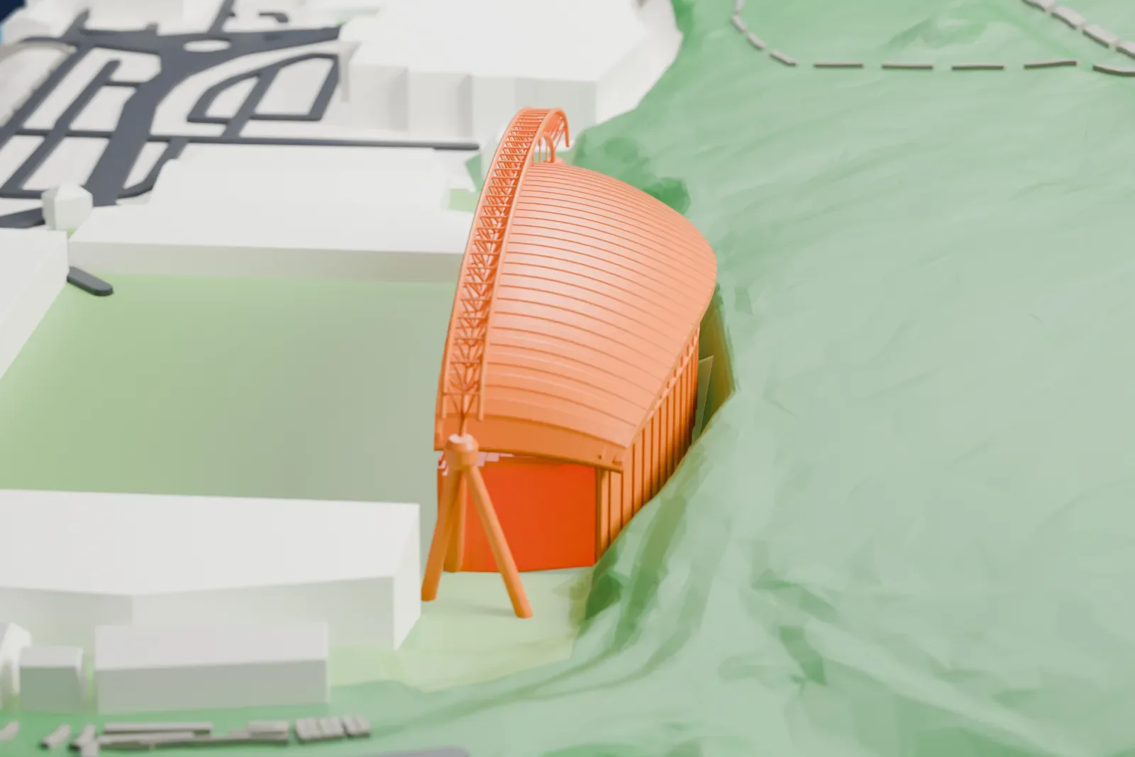 A white 3D print of the Kilner Bank Stand at Kirklees Stadium, one tier under a roof that dips to each end beneath a white arched truss on corner legs, among streets and buildings.