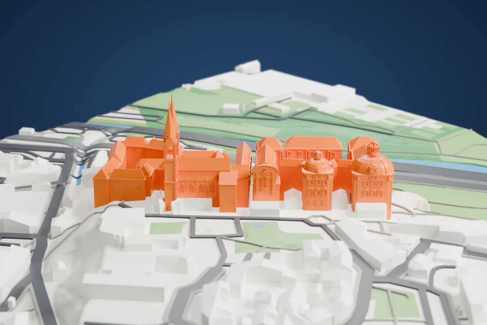 A white 3D print of Klosterneuburg Abbey, a tall monastery complex among the surrounding streets and buildings.
